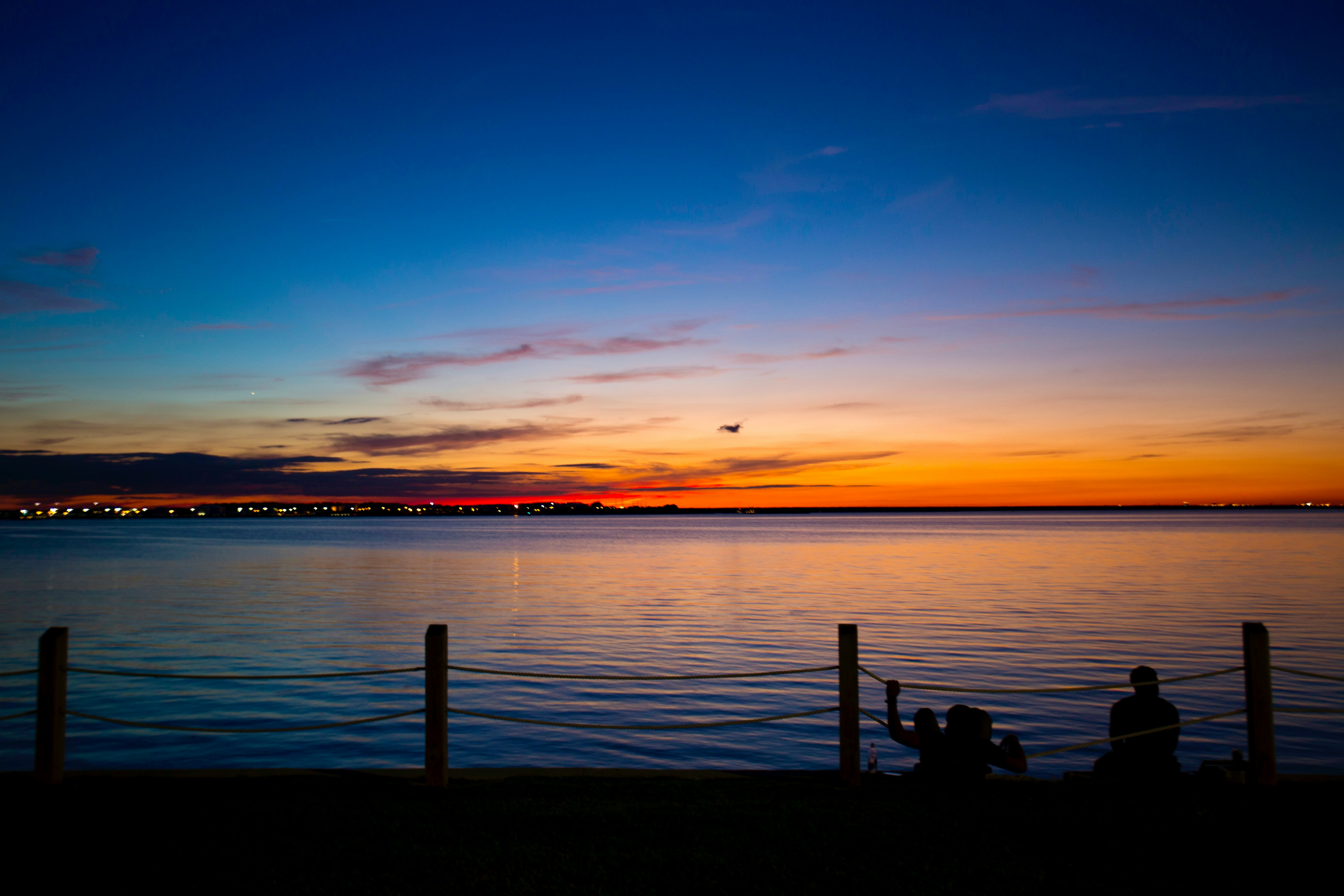 brown wooden dock on sea during sunset